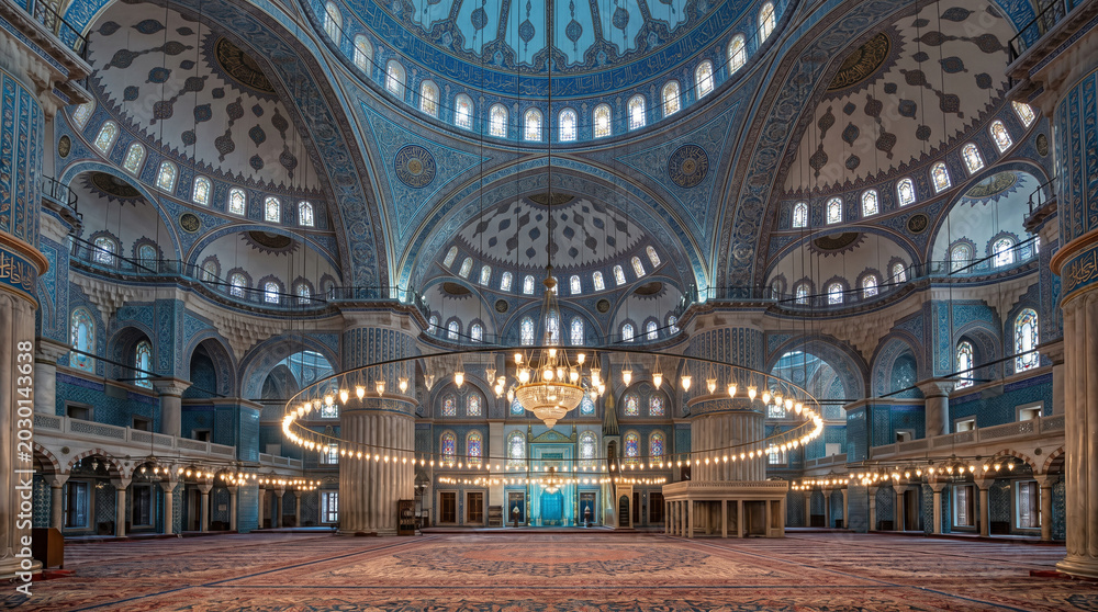 Obraz premium Majestic domed mosque interior design decorated with blue ceramic tiles and glowing cascading chandeliers artwork