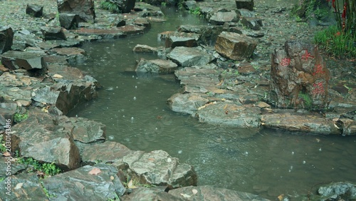 Valokuva Close up of rocks and water surface in a stream during rain
