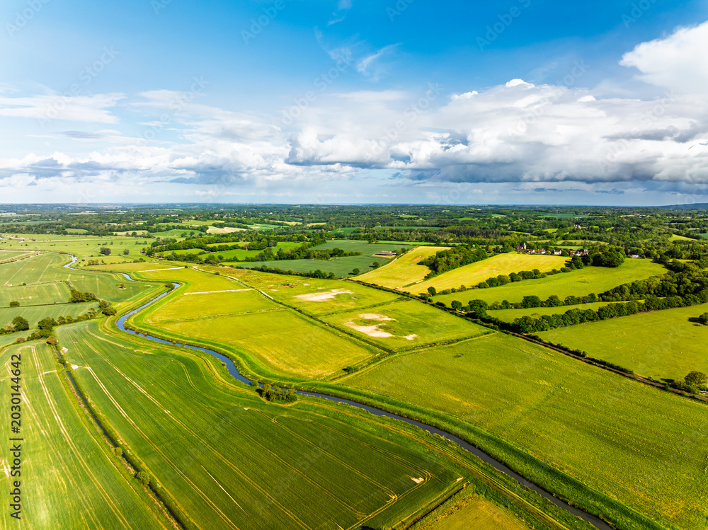 Obraz premium Fields and farms over Bodiam Castle, Bodiam, Robertsbridge, East Sussex, England
