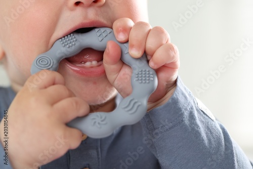 Принти на полотні First baby teeth. Cute child with teether at home, closeup