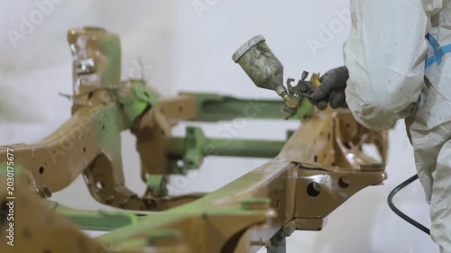 Treating the frame of an SUV with an anti-corrosion compound and acidic primer