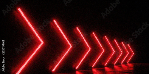 Photos Perspective view of red neon arrow lights forming a glowing tunnel path on dark