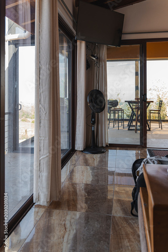 Modern vacation rental interior opening onto a scenic balcony view