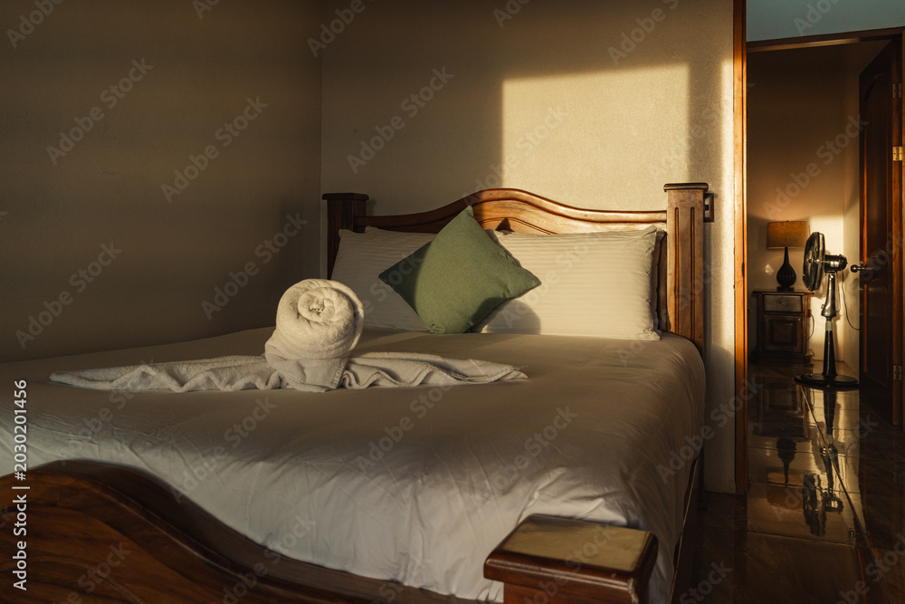 Φωτογραφία Cozy bedroom interior with bed and towel art
