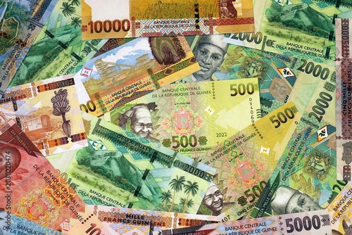Photography Guinean franc money bills in pile on table