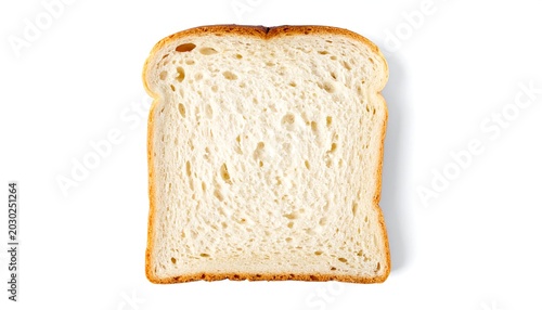 A single, top-down view of a light-colored bread slice. It sits on a white surface with visible texture and shadow