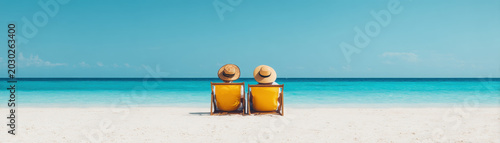 Beach ocean couple vacation summer relaxation us labor day seaside chairs on white sand under blue sky calm turquoise water tranquil escape