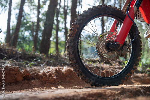Konstfotografi Close up of dirt bike wheel on muddy trail in forest, showcasing adventure and o