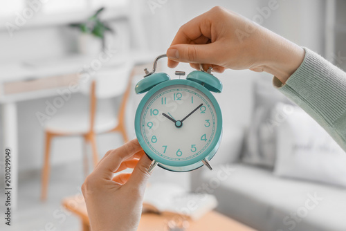 Female hands setting time o...