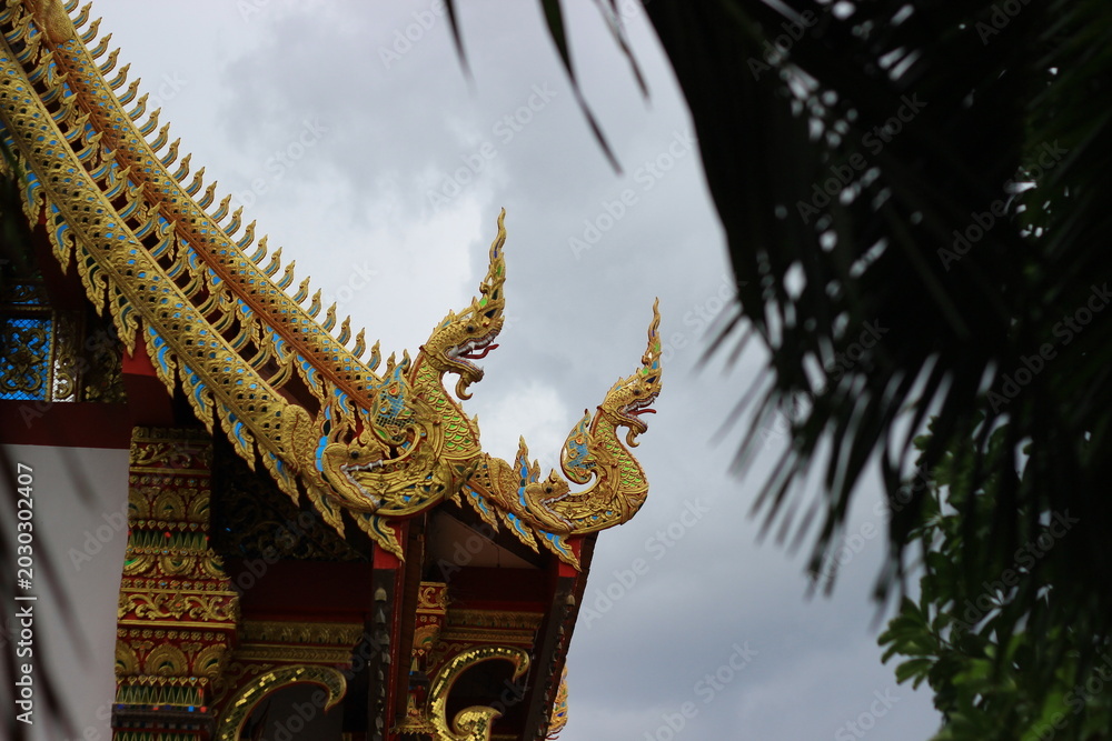 Fototapeta premium The temple roof features beautiful Naga (serpent) motifs.