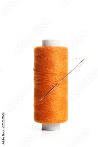 Orange sewing thread spool ...