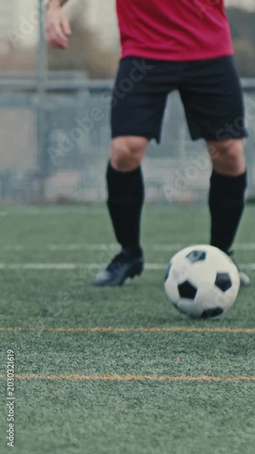 soccer player kicking ball
