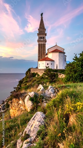 Serene coastal scene with a white church on a rocky cliff