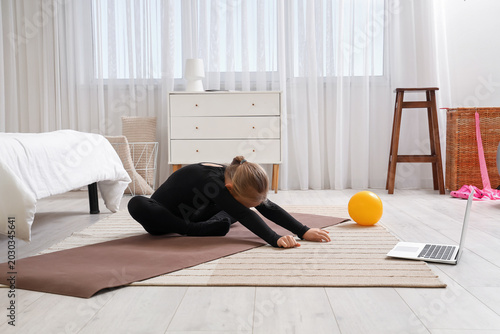 Little girl with mat and la...