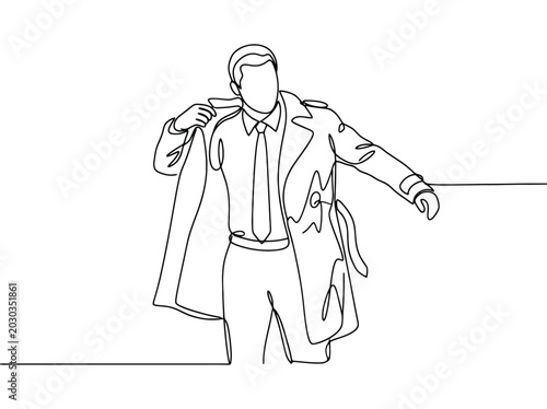 Man in trench coat and tie adjusts collar while looking forward with confidence and determination