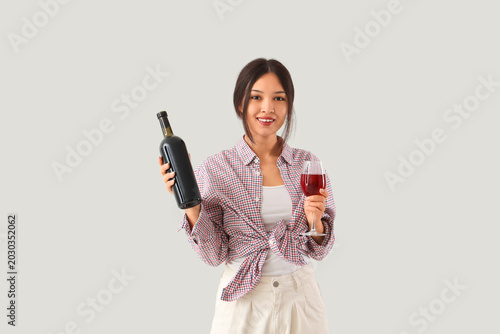 Young Asian woman with bott...