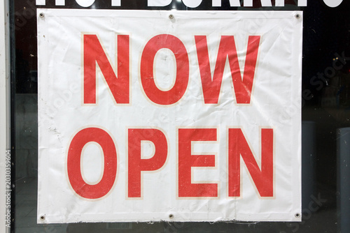 фотографія A white now open sign placed on a storefront window in Vidor, Texas