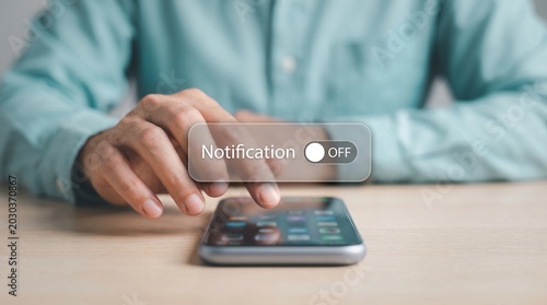 Man turning off mobile notifications on smartphone for digital detox and focus