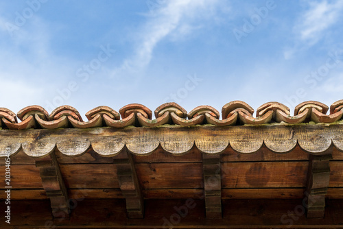 Old Rooftop Against Cloudy Sky Close Up.