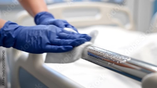 Cleaning and Sanitizing Hospital Bed Rails in Bright Clean Room