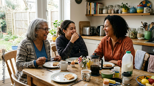 Authentic Multigenerational Family of Three Generations Sharing Genuine Laughter at Sunlit Kitchen Table, Candid Emotional Lifestyle Connection Stock Photo
