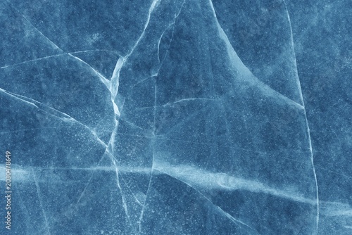 Abstract Frost Pattern on Glass Surface with Cracked Ice Texture and Blue Tint