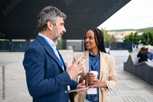 Business colleagues collaborating outdoors during a coffee break
