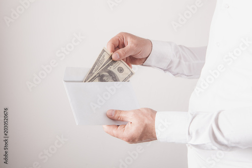 The man opens the letter and withdraws money