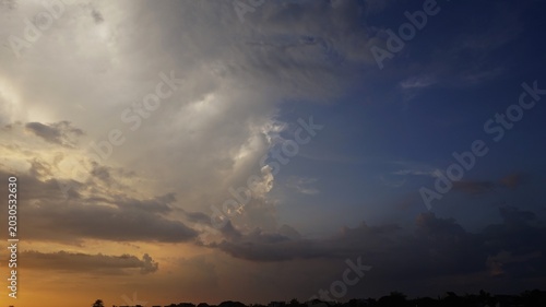 sky background, The slightly cloudy afternoon sky with black clouds highlighted by the yellow afternoon sunlight looks beautiful and dramatic.