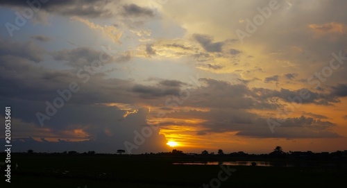 beautiful and dramatic afternoon sky with blackened white clouds and orange afternoon sunlight