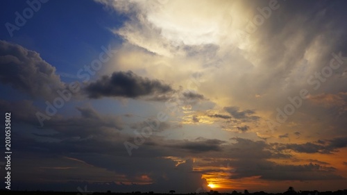 beautiful and dramatic afternoon sky with blackened white clouds and orange afternoon sunlight