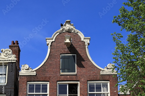 Brouwersgracht Canal House Facade with Bell Gable and Black Crow Close Up in Amsterdam, Netherlands