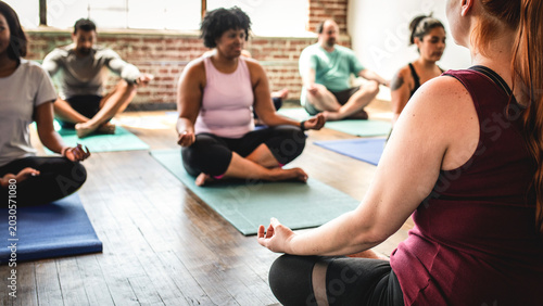 Photos Diverse group practicing yoga together