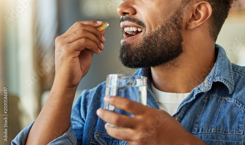 Photos Hands, water and man with medicine at house for health, medical dosage and supplements