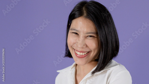Photos Smiling Asian Woman with Bob Haircut Posing Against Purple Background