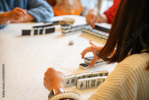 Family playing a game of Mahjong