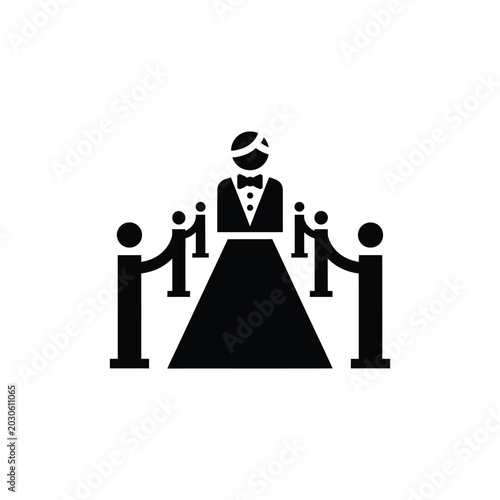 Foto Black silhouette of a person in a tuxedo walking on a red carpet with stanchions
