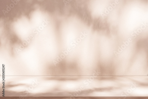 Autumn studio background with warm beige tones, soft leaf shadows and soft natural lighting on wall and floor.Abstract seasonal backdrop for cosmetic products,Fall seasonn promotions,mockup display