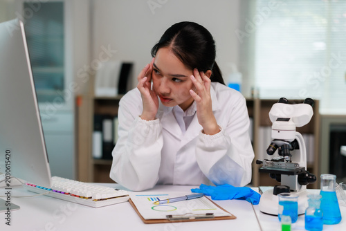 Foto Female scientist experiencing intense headache and stress in a research laborato