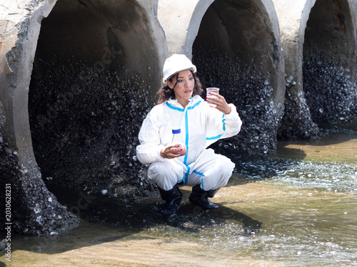 Photos Environmental engineers in chemical protective suits are collecting samples of contaminated water, ecologically and industrially, from nearby areas for testing