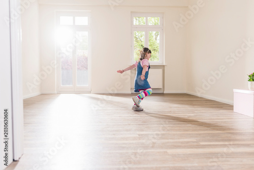 Happy girl running in empty apartment