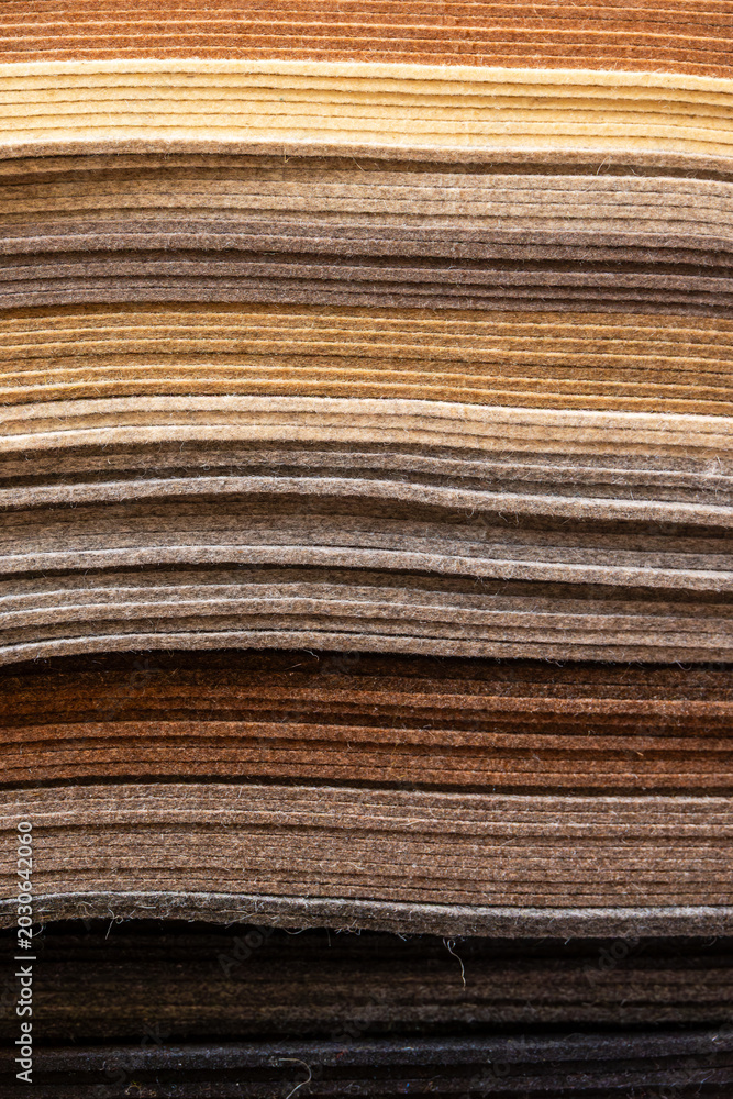 Fototapeta premium Natural brown felt fabric layers creating earthy textile texture background