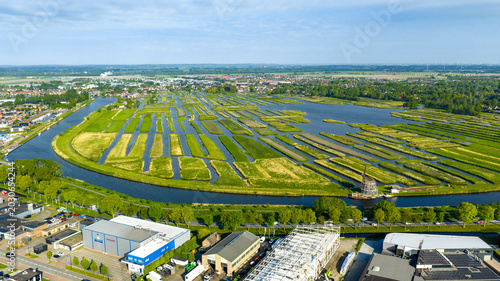 Aerial view of the Oosterdel nature reserve with its unique network of small islands and water channels under a clear sky in Broek op Langedijk, Noord-Holland, Netherlands.