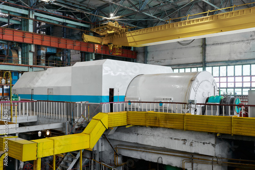 Powerful industrial steam turbine generator set operating in a thermal power plant machine hall