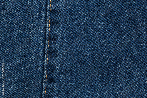 Fotografie dark  blue jeans denim fabric texture background with seam