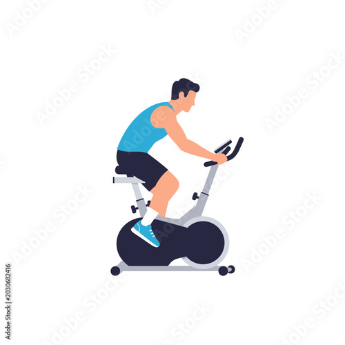 Athletic young man cycling on a stationary exercise bike