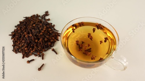 Clove tea on white table. Healthy drink.