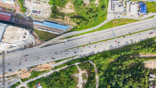 Photos Top down aerial view of a multi-lane highway with moving traffic running adjacen