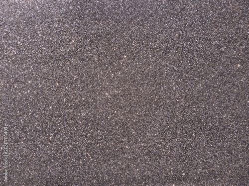 Gray sparkle background. Gray glitter background. Metallic gray glimmer. Abstract twinkle texture. Silver glitter surface. Glimmer layout. Holiday layout. Diamond surface. Celebration background.