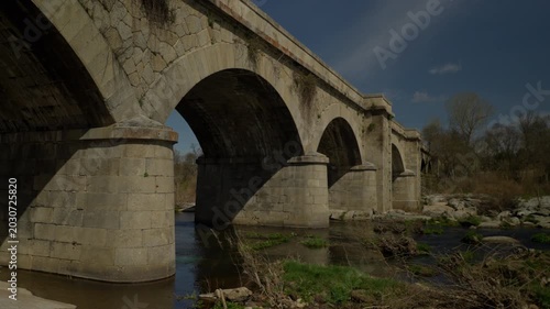 Stone arch bridge connecting river banks